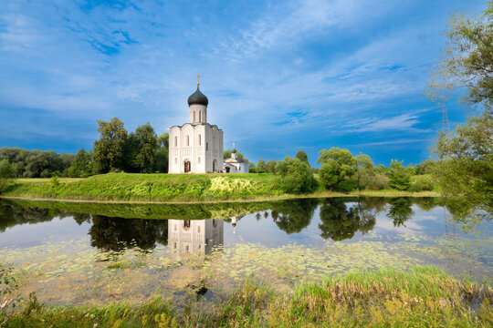 Church of the Intercession on the Nerl with Reflection in River Surrounded by Trees in Vladimir