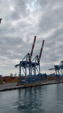 26 April 2026, Italy, Liguria, Genoa, Port Terminal Contenitori - vertical close up of PSA SECH STS cranes semi-circular beam seaport gantry for unloading and loading infrastructure