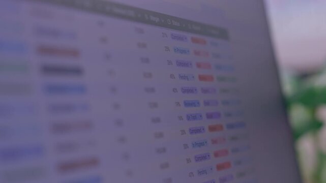 Blurred Spreadsheet on Computer Screen with Colorful Data Rows, Digital Table Interface and Hand Using Stylus for Focused Electronic Record Analysis in Modern Office Background Workspace
