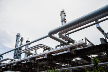 Industrial oil and gas pipeline rack structure at petrochemical processing facility © Rangsarit