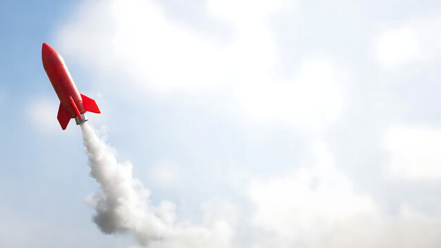 A bright red rocket blasting off into a clear blue sky with white smoke trailing behind it, symbolizing progress and achievement
