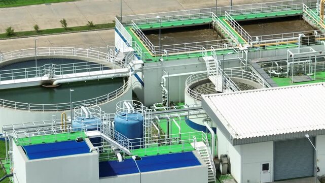 A modern industrial wastewater treatment facility with clarifier tanks and filtration systems, representing ESG practices, water recycling, pollution control, and sustainable industry.
