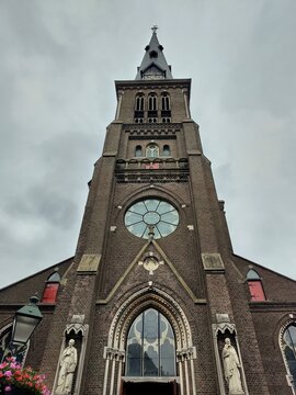 Frog perspective shot from below of the front of Sint-Franciscuskerk, in Oudewater, Netherlands. Example of 19th century neogothic architecture church. 