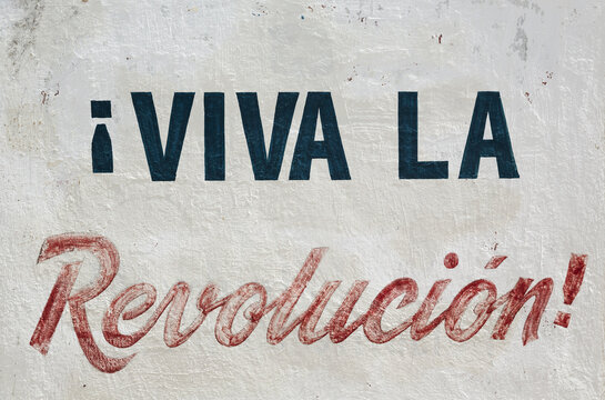 View of the Viva la Revolucion mural painted on a textured wall in Guantanamo, Guantanamo, Cuba.