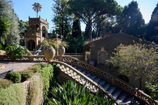 A picturesque view of the historic Villa Comunale park in Taormina, showcasing its unique architecture and vibrant botanical gardens