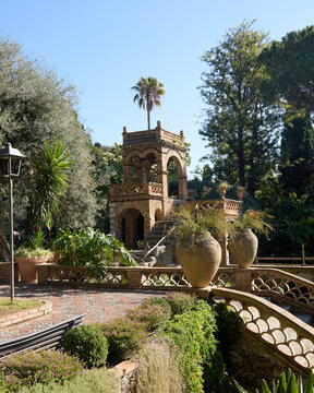 A picturesque view of the historic Villa Comunale park in Taormina, showcasing its unique architecture and vibrant botanical gardens