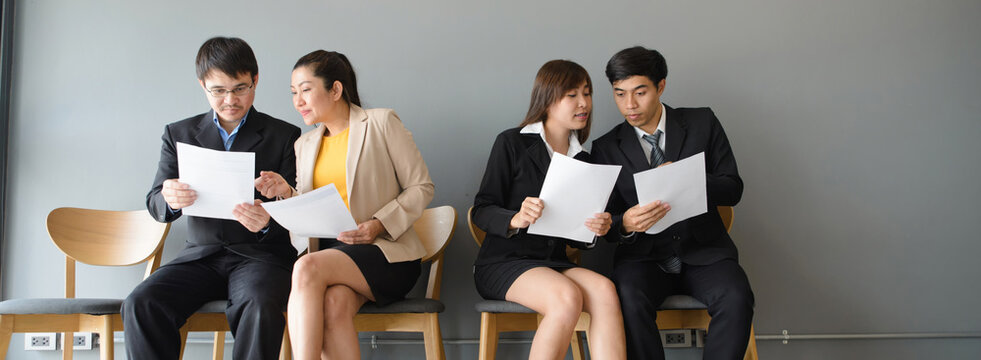 Group of professional businesspeople meeting and review documents in workplace. Teamwork, colleagues and employee, with businessmen and businesswomen working together in corporate business office