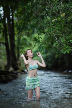 young woman in Green bikini on the Stream