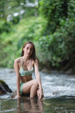 Portrait young woman in bikini on the Stream