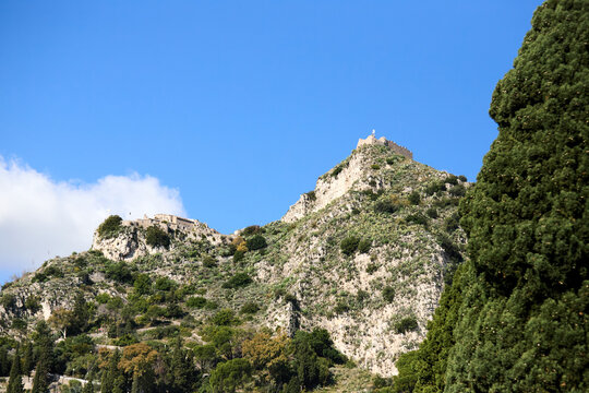 The historic Castello di Saraceno stands majestically on a rugged peak in Taormina, Sicily