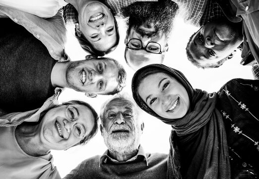 Diverse smiling friends and family circle seen from below