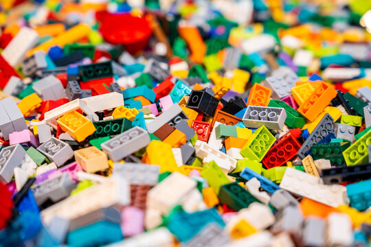 A pile of multicolor of many Lego toy blocks in various shapes and different sizes. Toys and games. Leisure and recreation.