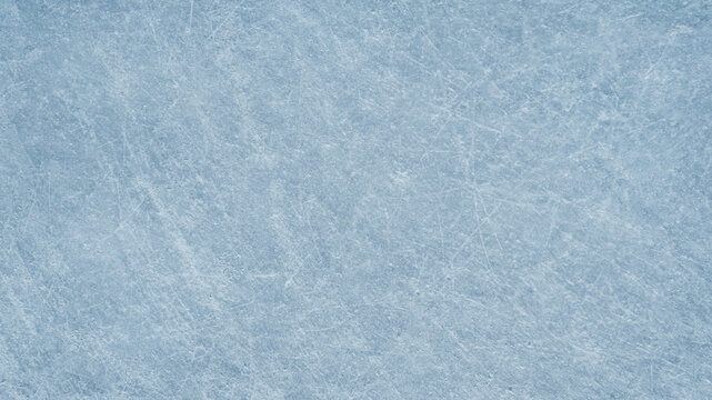 An ice surface as an ice rink with ice skates tracks. Winter sports texture. Poster with copy space.