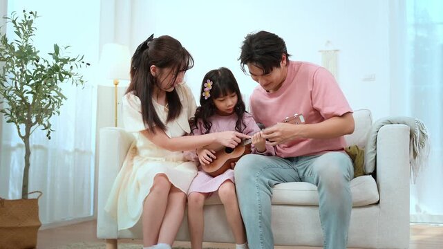 Family Enjoys Time Together While Playing Music in Their Living Room