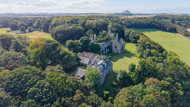 Aerial view of historic Seacliff House ruins surrounded by countryside in East Lothian Scotland
