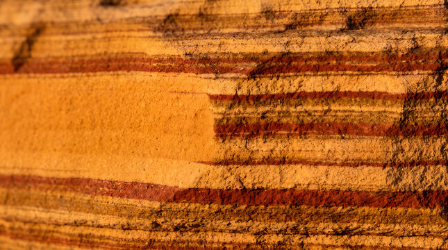 Close-up of layered orange sandstone rock texture background