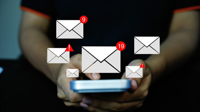 Person holding a smartphone with floating hologram envelope icons, unread message counts and warning alerts, Holographic email notifications on smartphone.