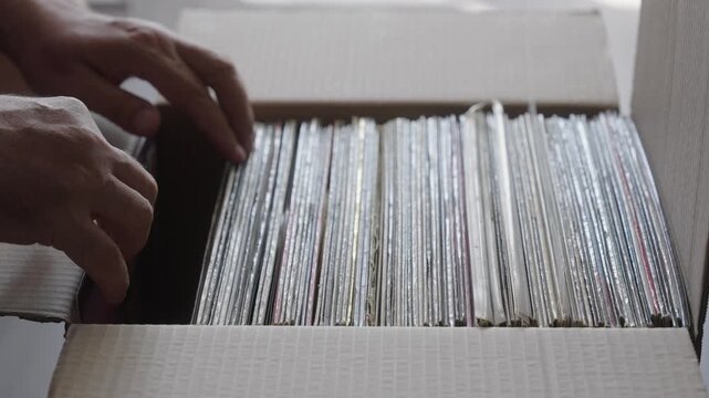 Hands Browsing Vinyl Record Collection in Cardboard Box
