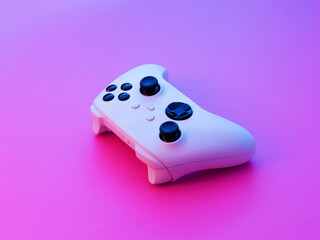 White Game Controller in Modern Neon Purple Light Setup © stokkete