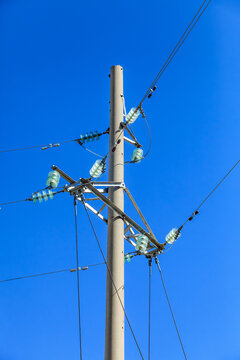 Power lines stretch across a vivid blue sky