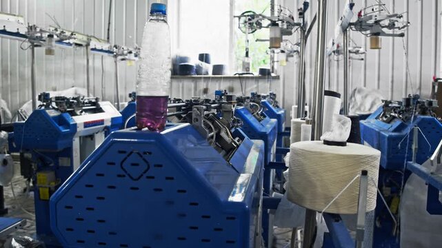 Industrial knitting machines operate automatically with yarn feeding through production system. Lubricating oil is used to reduce friction between moving parts.