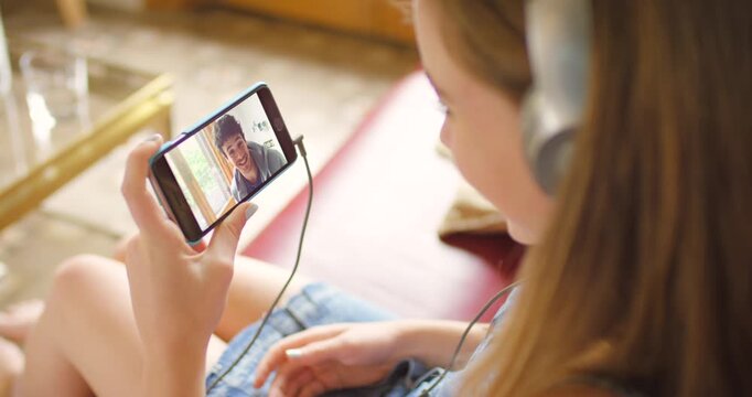 Woman, phone and wave for hello on video call, virtual conversation and speaking to boyfriend. Couple, love and bonding online and talk on technology, internet connection and communication at home