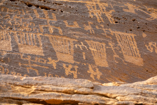 Ancient inscriptions carved in rows on a sandstone cliff, Al Madinah Province, Alula, Saudi Arabia