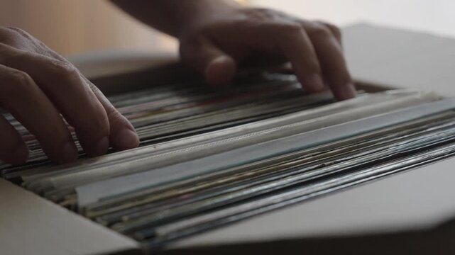 Hands Browsing Vinyl Record Collection in Cardboard Box