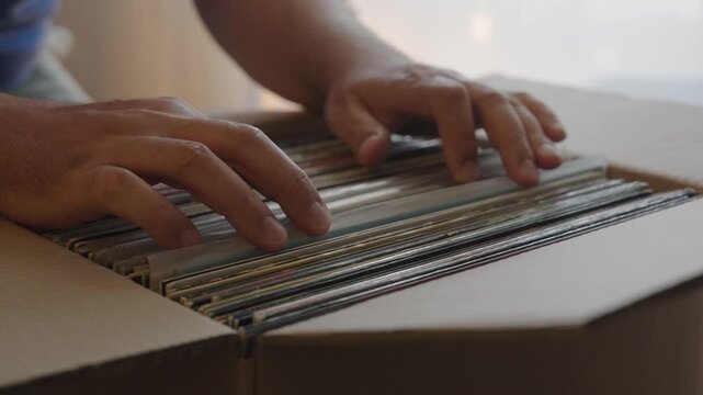 Hands Browsing Vinyl Record Collection in Cardboard Box