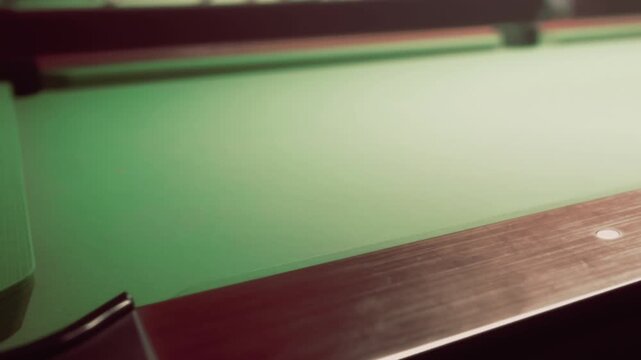 In a warm, inviting lounge, a classic billiards table awaits eager players. The soft green felt glimmers under gentle lighting, hinting at upcoming games and laughter as dusk settles in.