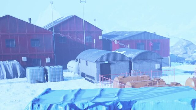 In a frigid landscape, red buildings stand against white snow, providing shelter to scientists.