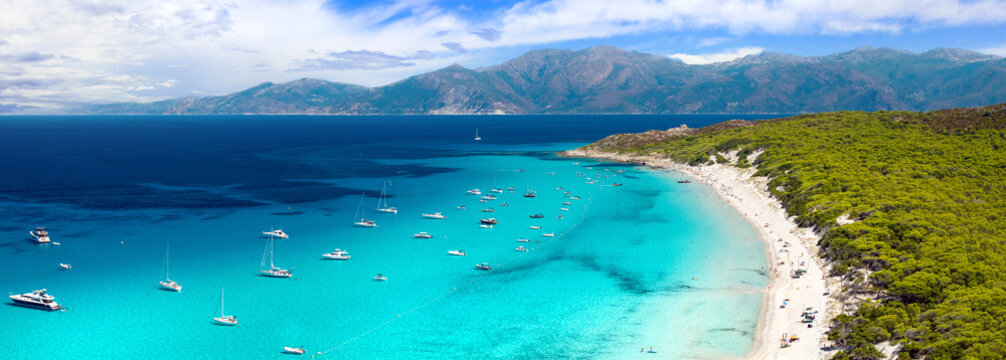 Saleccia Beach Agriates Corsica drone panorama photo. Turquoise Caribbean sea with sailing yachts and pine forest. High resolution 15K World Print fine art aerial landscape