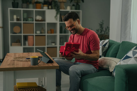 Man opening surprise gift box with happy expression