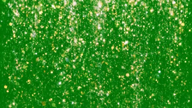 Golden glitter particles falling against a green screen background dynamic progression video gold sparkle