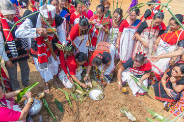  A Mising elder partaking in traditional rice beer as community members arrange ceremonial offerings of fish and rice during the Lhigang rituals in Guwahati,Assam,India on 19 february 2025. © Kulajit