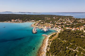 Fototapeta premium Aerial drone panorama of the western part of Silba Island, Croatia, surrounded by the crystal-clear Adriatic Sea. The picturesque coastal village, turquoise shoreline and Mediterranean vegetation