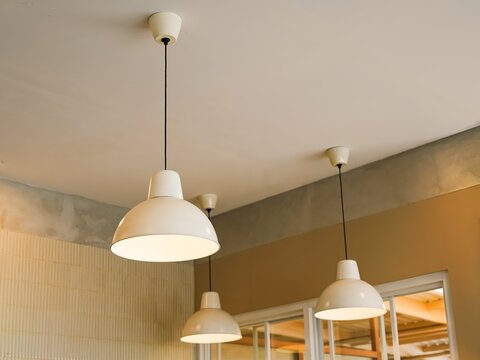 White pendant lamps hanging in cafe interior