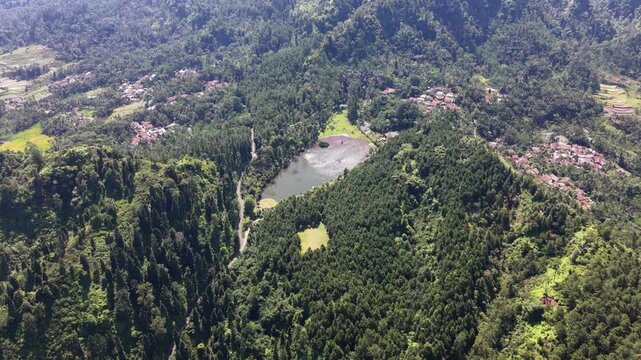 Scenic View of Telaga Kumpe Surrounded by Lush Green Forest, Central Java, Indonesia.