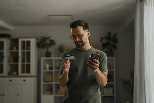 Man shopping online using smartphone and credit card