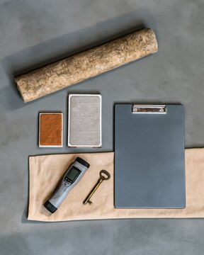 Winter home energy kit featuring a thermal reader and clipboard, with textured pipe lagging and filters for boiler service and heating maintenance
