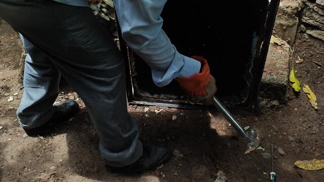 Hitting a metal sheet with a hammer to separate it from metal frame