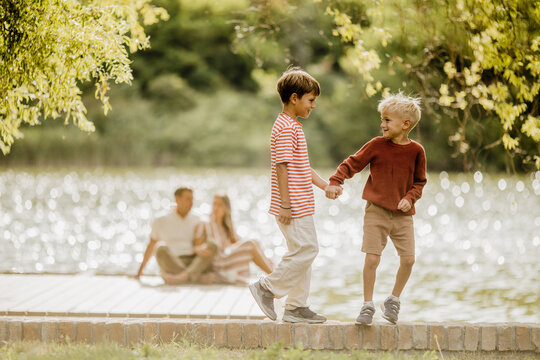 Fun moments of friendship by the serene lakeside with joyful children