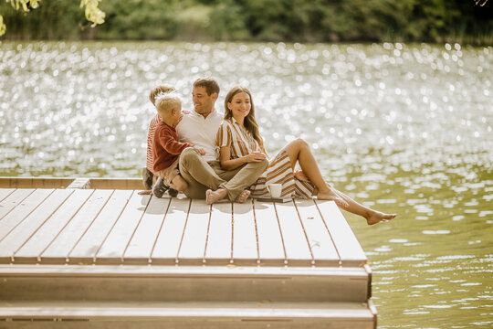Sunlit moments by the shimmering lake with family enjoying a peaceful day