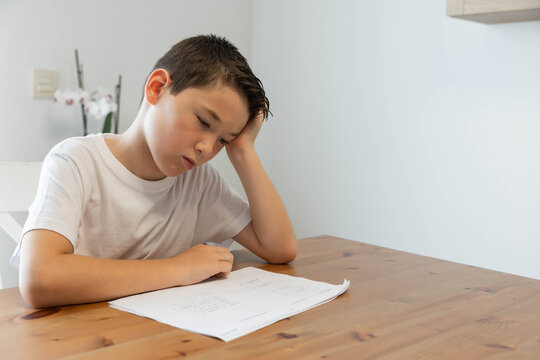 A sad and disappointed child, reflects on his worries or a failed test; he is suffering from an unfair situation. Distressed, frustrated, and depressed preteen, feeling unwell and exhausted