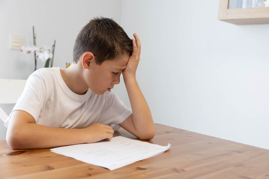 A sad and disappointed child, home alone, reflects on his worries or a failed test; he is suffering from an unfair situation. A preteen who is distressed, depressed, and feeling unwell and exhausted.