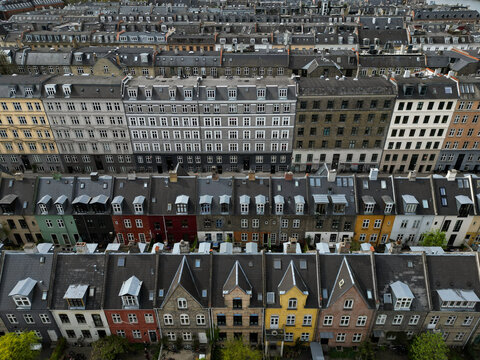 Aerial view of colorful historic residential buildings with gabled roofs and dormer windows in Copenhagen, Denmark.