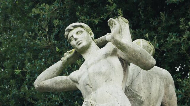 Static shot of stone worker statues at Tartiere monument in Oviedo