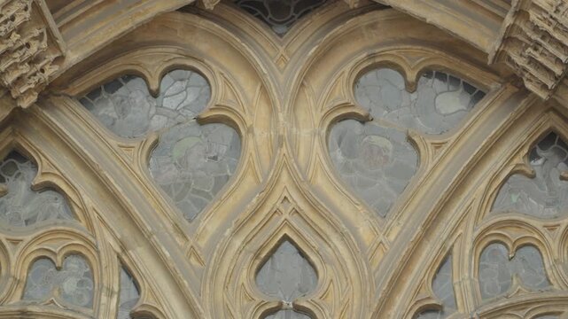 Detailed view of stone tracery and stained glass on Oviedo Cathedral facade