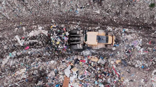 Loader moves mixed refuse at landfill, showing scale of plastic pollution crisis