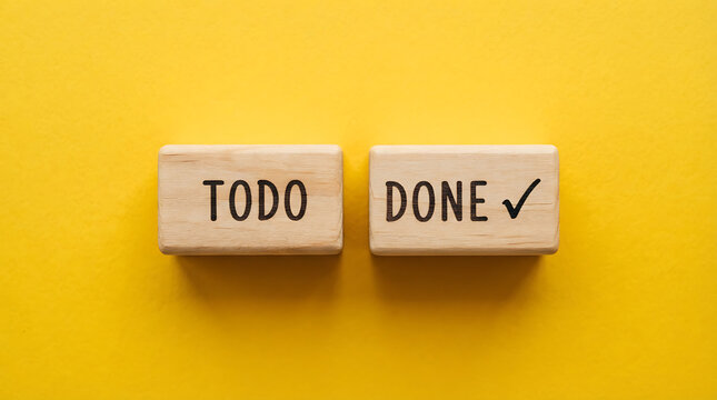 Two rectangular wooden blocks positioned on a solid yellow background, with the word todo engraved on the left block and the word done followed by a checkmark symbol engraved on the right block